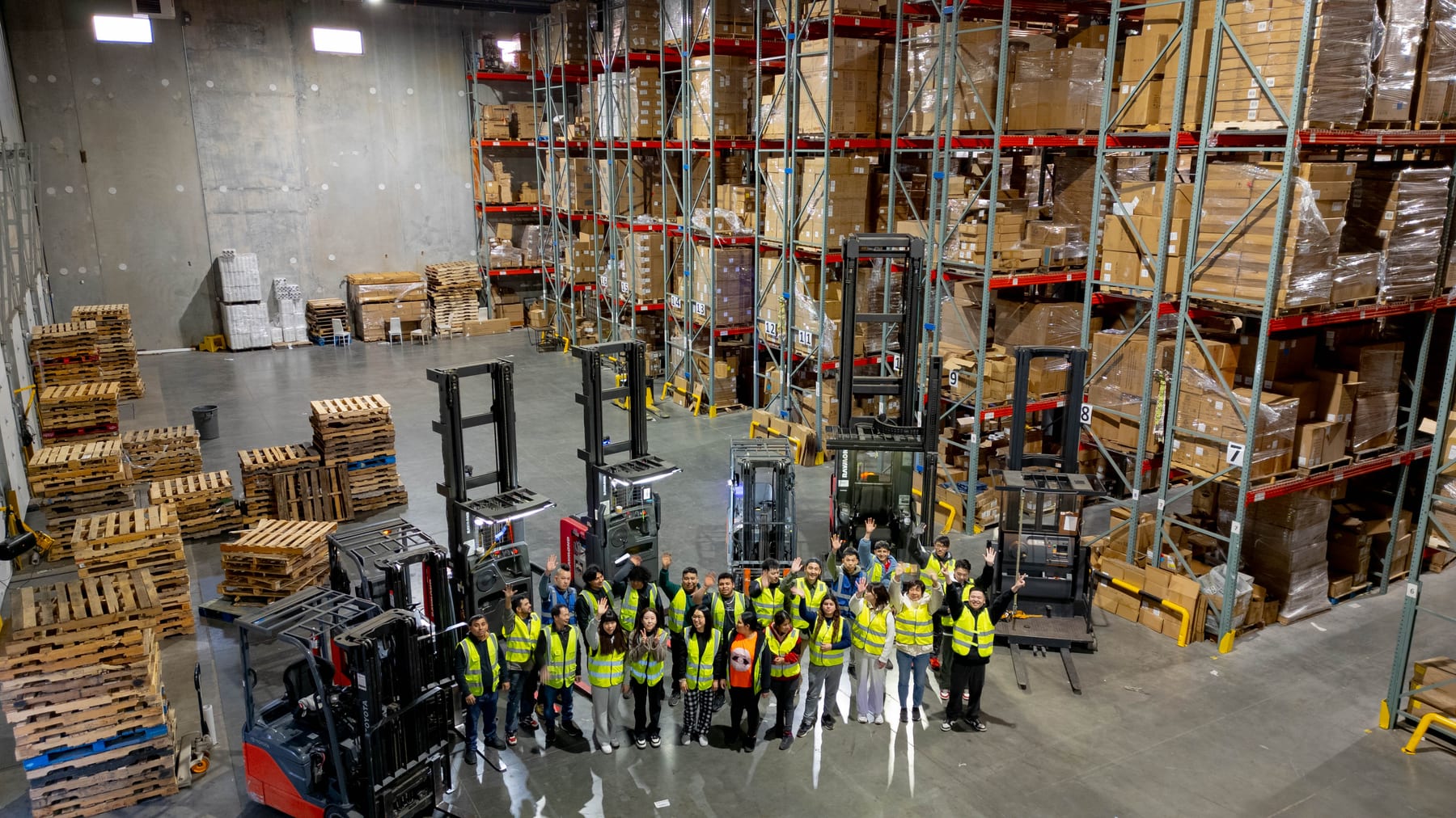 The MashBond team on the floor of a U.S. distribution warehouse, surrounded by pallet racking and forklifts